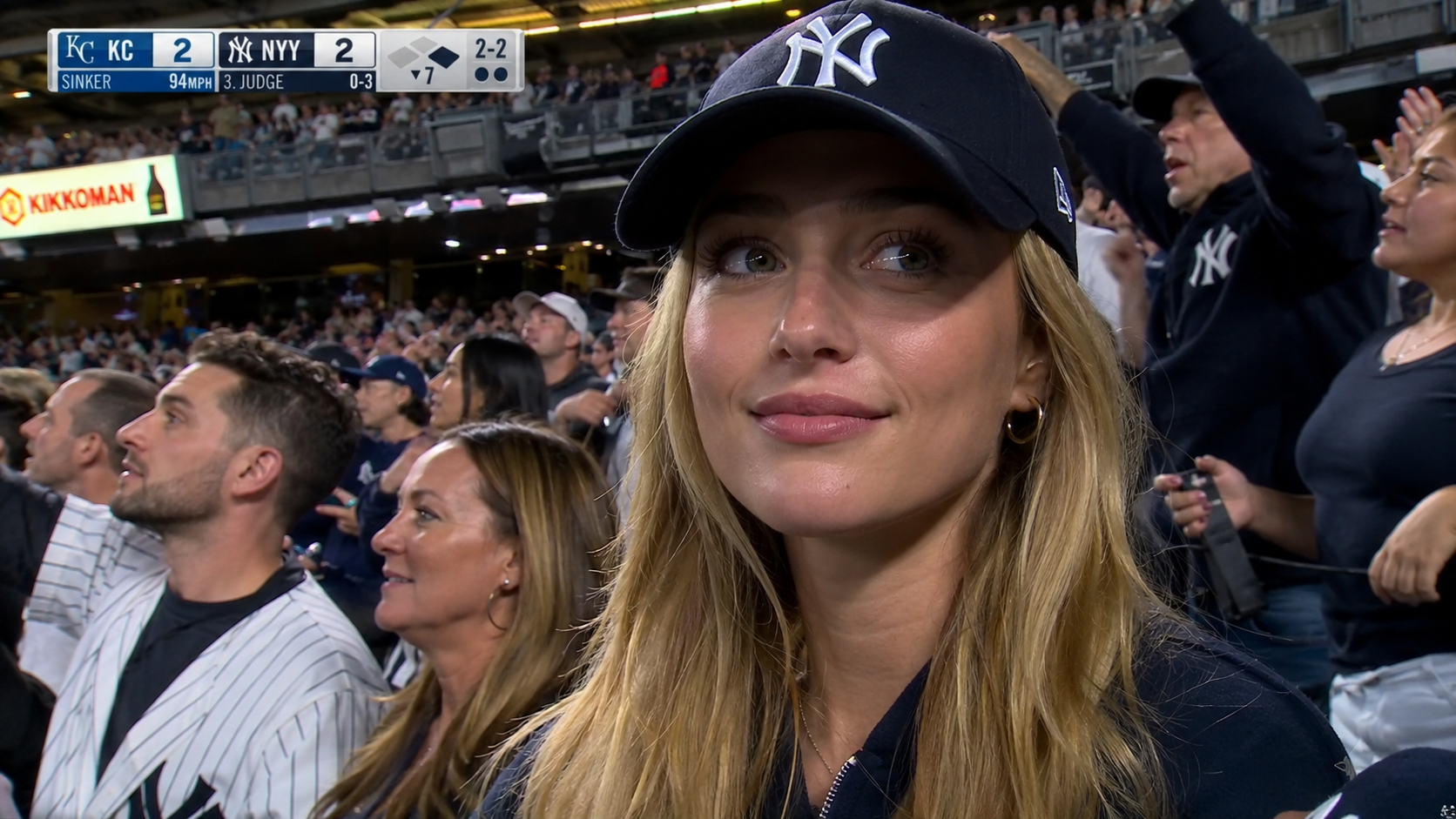 AI baseball stadium video generator fan-cam broadcast prompt with black hat subject
